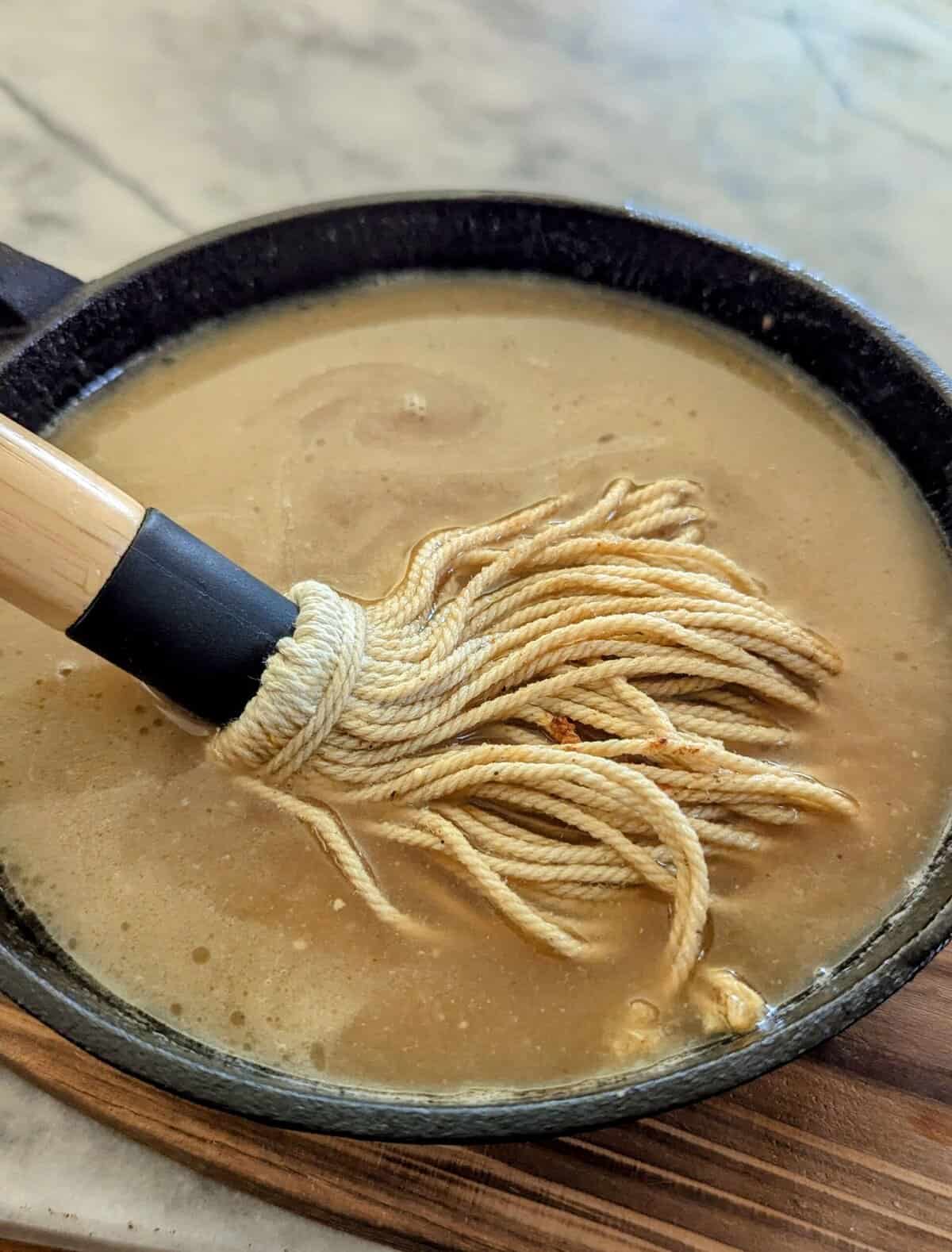 savory tangy bbq mop sauce in cast iron pan